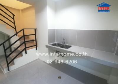 Modern building interior with staircase and kitchenette