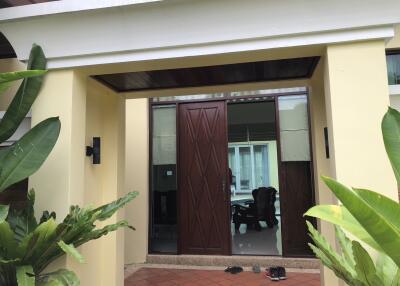 Front entrance of a modern home with large wooden door
