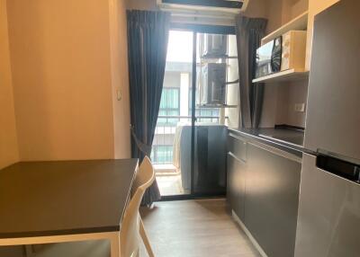 Compact kitchen area with modern appliances and ample natural light