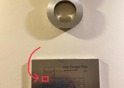 Fire escape plan on a building wall next to apartment number 8