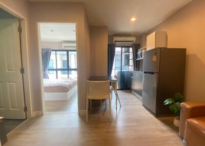 Compact studio apartment interior with combined living, kitchen, and bedroom space