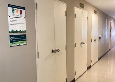 Corridor with multiple closed doors and informational signs