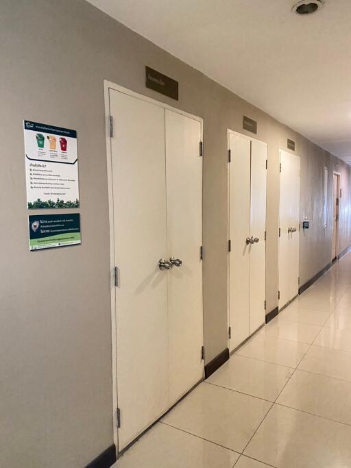 Corridor with multiple closed doors and informational signs