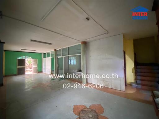 Spacious unfurnished living room with large windows and tiled floor