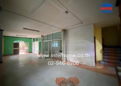 Spacious unfurnished living room with large windows and tiled floor