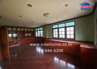 Spacious living room with wooden floors and built-in cabinetry