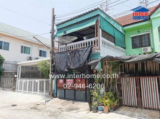 Two-story residential building with front gate and balcony