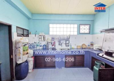 Spacious kitchen with blue tiles and ample storage