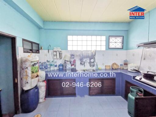Spacious kitchen with blue tiles and ample storage