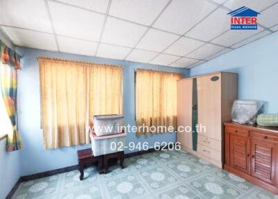 Bright bedroom with wooden furniture and blue tiled floor