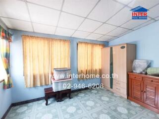 Bright bedroom with wooden furniture and blue tiled floor