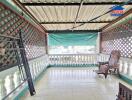 Spacious covered balcony with lattice privacy walls and outdoor seating