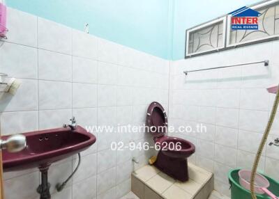 Spacious bathroom with bright tiling and modern fixtures