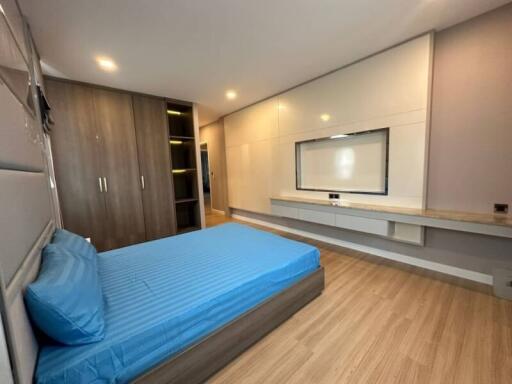 Modern bedroom with wooden furniture and ample lighting