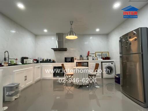 Spacious modern kitchen with stainless steel appliances and ample storage
