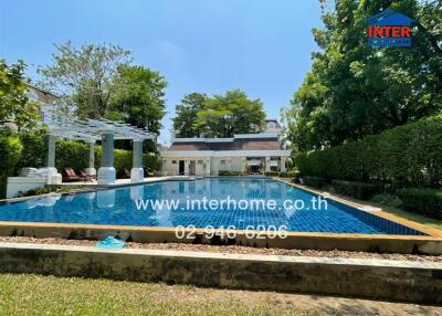 Luxurious backyard with a large swimming pool and lounge chairs in a residential property