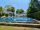 Luxurious backyard with a large swimming pool and lounge chairs in a residential property