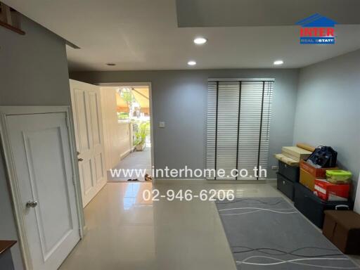 Well-lit entrance hall leading to the house interior and garage