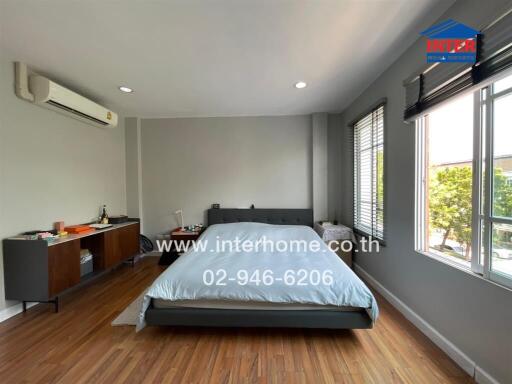 Spacious and well-lit bedroom with modern amenities