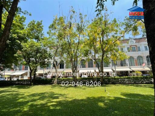 Elegant building exterior viewed from a lush garden