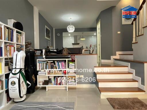 Spacious and modern living room with staircase and bookshelves