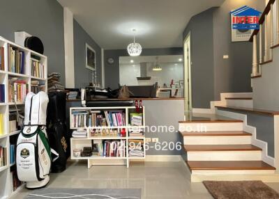 Spacious and modern living room with staircase and bookshelves