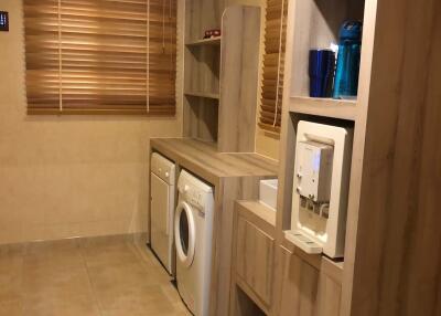 Modern laundry room with built-in storage cabinets and appliances