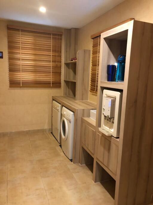Modern laundry room with built-in storage cabinets and appliances