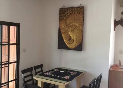Spacious dining room with Buddha artwork and modern furnishing