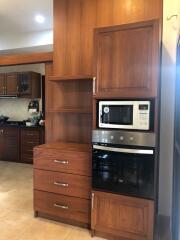 Modern kitchen with built-in appliances and wooden cabinetry