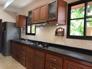 Spacious kitchen with wooden cabinets and modern appliances