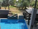 Luxurious outdoor pool area with garden and seating
