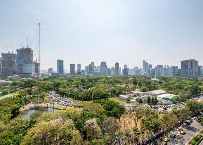Panoramic city view from a high rise building showing both urban skyline and green park areas