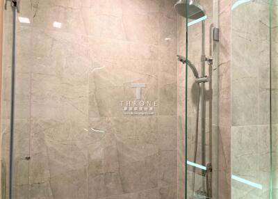 Modern bathroom with elegant marble finishing and glass shower