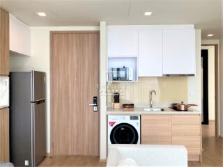 Modern compact kitchen with integrated appliances and open living space