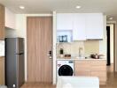 Modern compact kitchen with integrated appliances and open living space