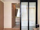 Modern bedroom with adjoining bathroom featuring glass shower doors
