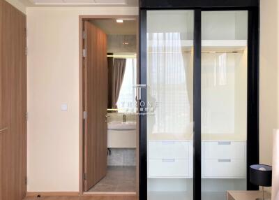 Modern bedroom with adjoining bathroom featuring glass shower doors