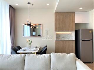 Modern living room with integrated dining and kitchen area