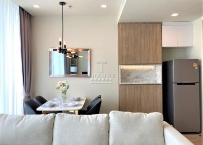 Modern living room with integrated dining and kitchen area