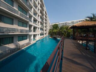 Luxurious residential building with a large swimming pool and ample balconies
