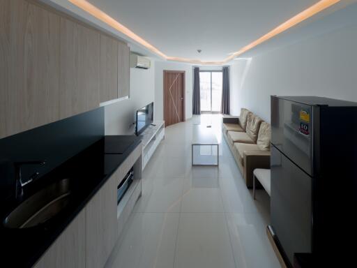 Modern kitchen and living room with integrated appliances
