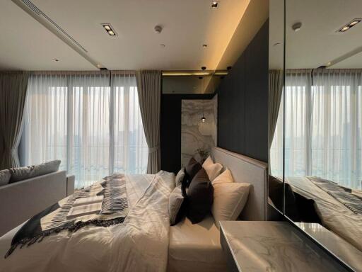 Modern bedroom with large windows and elegant interior design