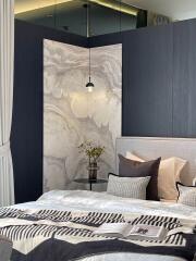 Elegant bedroom with marbled wall panel and sophisticated decor