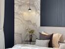 Elegant bedroom with marbled wall panel and sophisticated decor