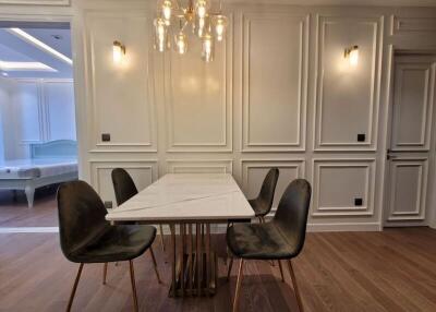 Elegant dining room with classic white paneling and modern furniture