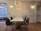 Elegant dining room with classic white paneling and modern furniture