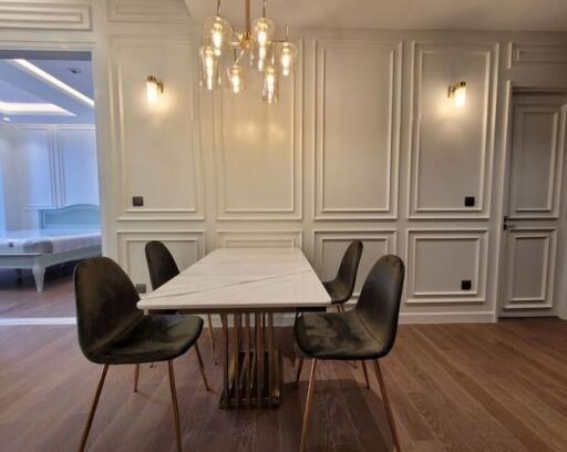 Elegant dining room with classic white paneling and modern furniture