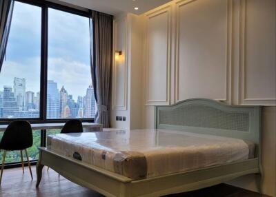 Elegant bedroom with a large window view of the cityscape