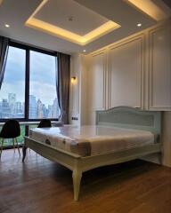 Elegant bedroom with a large window view of the cityscape